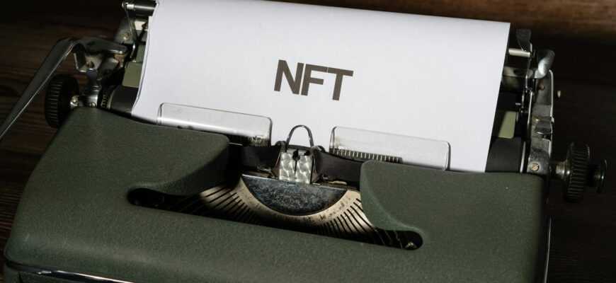 Close-up of a vintage typewriter with the word 'NFT' typed on paper, symbolizing digital innovation.