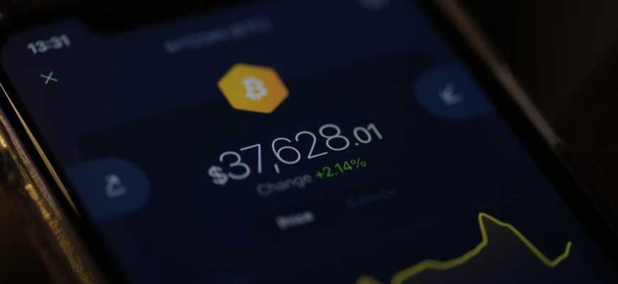a close up of a cell phone with a bitcoin on it