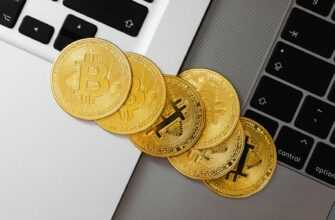 Golden Bitcoin coins spread across laptop keyboards showcasing digital currency and finance.