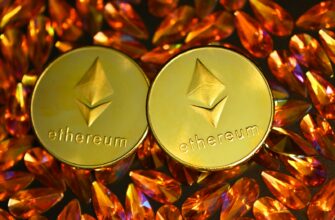 two gold ethereum tokens sitting on top of a pile of crystals