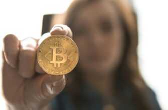 woman holding Bitcoin