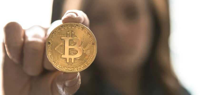 woman holding Bitcoin