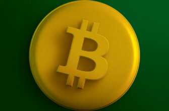 a yellow bit coin sitting on top of a green surface