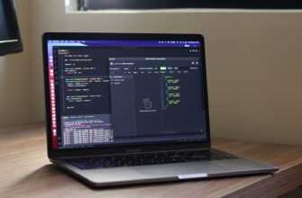 a laptop computer sitting on top of a wooden desk