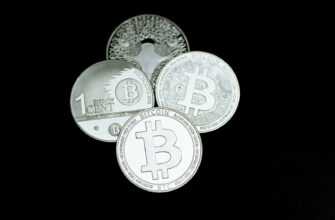 a pile of silver bitcoins sitting on top of each other